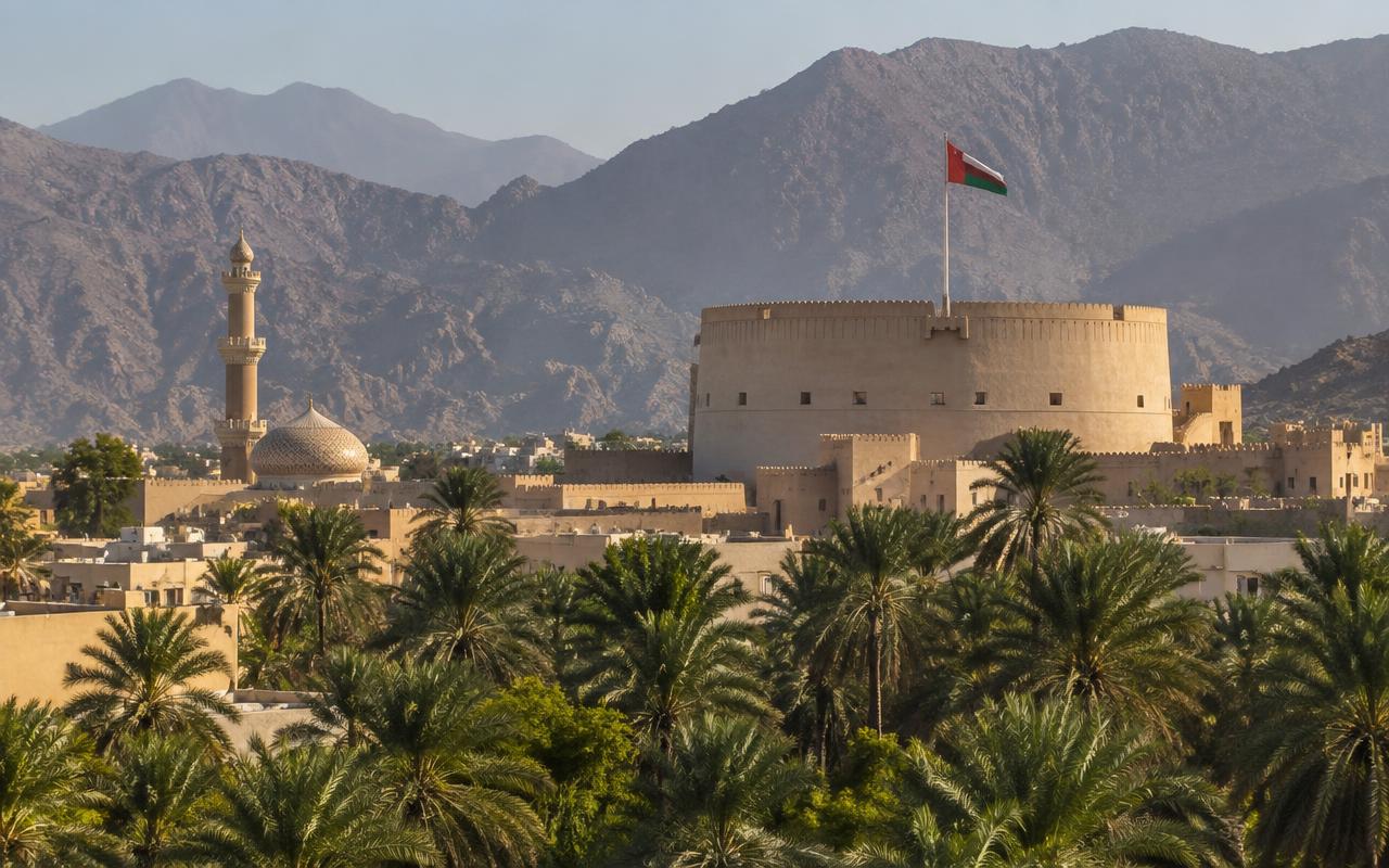 The round tower of Nizwa Fort with the Al Hajar Mountains behind it